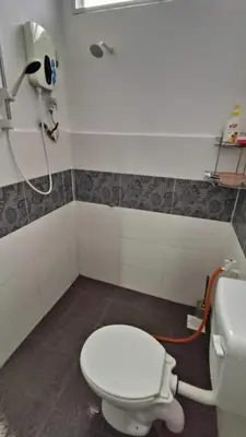 a bathroom with a toilet and a shower at Homestay Kak Rose 2 Kuala Lipis in Kampong Temperah