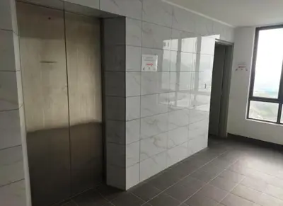 a bathroom with a walk in shower with tile walls at 4H Guesthouse Cameron Highland in Brinchang