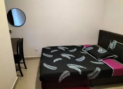 a black couch with a blanket on it in a room at 4H Guesthouse Cameron Highland in Brinchang