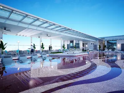 a building with a pool of water and chairs at Fifth Avenue Hotel in George Town
