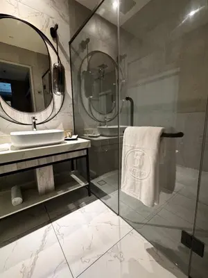 a bathroom with a sink and a mirror at Fifth Avenue Hotel in George Town
