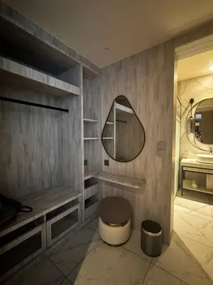 a bathroom with a sink and a mirror and a toilet at Fifth Avenue Hotel in George Town