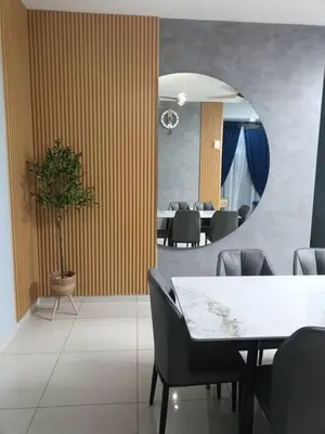 a dining room with a table and a mirror at Homestay D'sasz Meru Ipoh in Ipoh