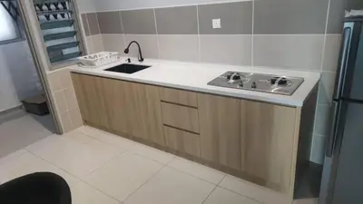 a kitchen with a sink and a refrigerator at Homestay D'sasz Meru Ipoh in Ipoh