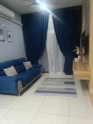 a blue couch in a living room with a blue curtain at Homestay D'sasz Meru Ipoh in Ipoh