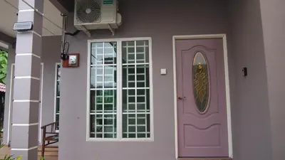 a house with a purple door and a window at D'Binjai Homestay & Roomstays Kuala Kangsar in Kuala Kangsar