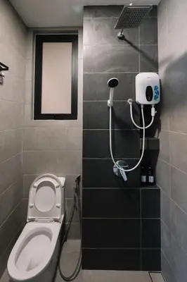a bathroom with a shower with a toilet and a window at Seaview Infinity Pool 2BR 2CP 8Pax Urban Suite 251 in George Town