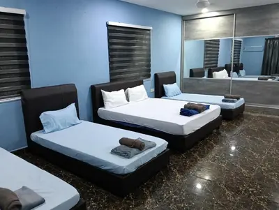 a room with two beds and a mirror at JSW PRAMLee Georgetown Penang in George Town