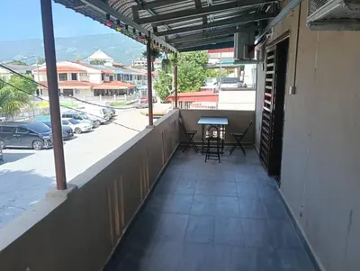 a balcony of a building with a table and chairs at JSW PRAMLee Georgetown Penang in George Town