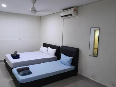 two beds in a small room with a mirror at JSW PRAMLee Georgetown Penang in George Town
