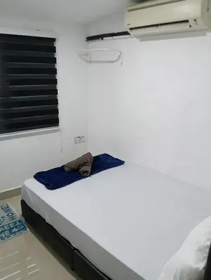 a bed in a room with a towel on it at JSW PRAMLee Georgetown Penang in George Town