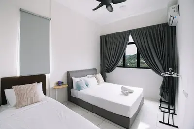 a bedroom with two beds and a window at NEW The Sun 3Bedrooms 10pax 2CP in Bayan Lepas