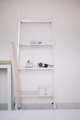 a white shelf with a toy car and towels at NEW The Sun 3Bedrooms 10pax 2CP in Bayan Lepas