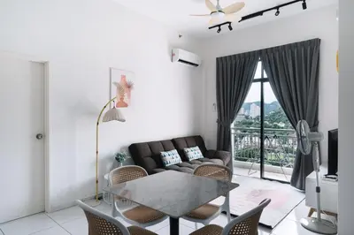 a living room with a couch and a table at NEW The Sun 3Bedrooms 10pax 2CP in Bayan Lepas