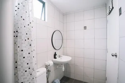 a white bathroom with a sink and a mirror at NEW The Sun 3Bedrooms 10pax 2CP in Bayan Lepas