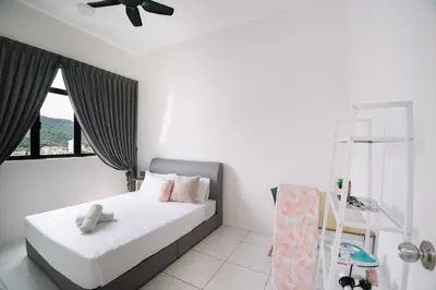 a bedroom with a bed and a ceiling fan at NEW The Sun 3Bedrooms 10pax 2CP in Bayan Lepas