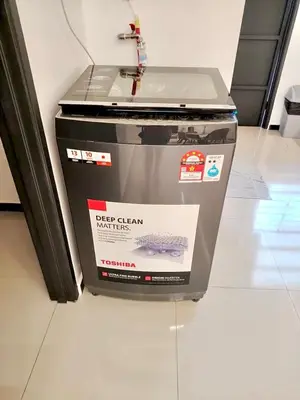 a large appliance sitting on a tile floor at Tpg Creek Lodge in Kamunting