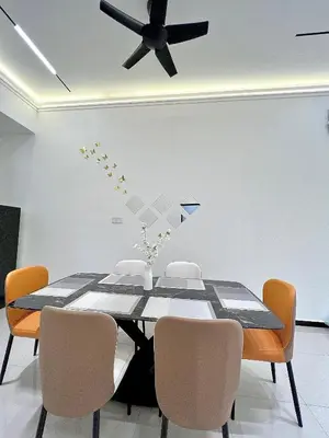a dining room with a table and a ceiling fan at Tpg Creek Lodge in Kamunting