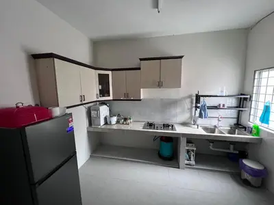 a kitchen with a sink and a refrigerator at Teratak Segar Bayu - Musslim Only Tanjong Malim Perak in TanjongMalim