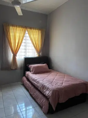 a bedroom with a bed with pink sheets and a window at Teratak Segar Bayu - Musslim Only Tanjong Malim Perak in TanjongMalim