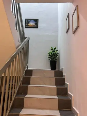 a stairway with a potted plant on the wall at Teratak Segar Bayu - Musslim Only Tanjong Malim Perak in TanjongMalim