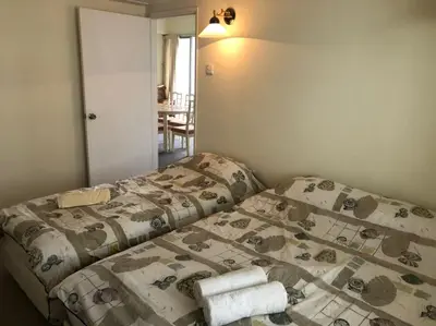 a bedroom with a bed with towels on it at Misty at Fraser's Hill in Bukit Fraser