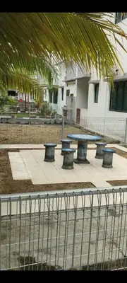 a group of tables and benches on a sidewalk at Pangkor Shu Yuan \u90a6\u54af\u5c9b\u5885\u82d1\u6d77\u6ee9\u522b\u5885 in Pangkor