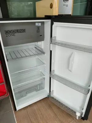 an empty refrigerator with its door open in a room at Pangkor Shu Yuan \u90a6\u54af\u5c9b\u5885\u82d1\u6d77\u6ee9\u522b\u5885 in Pangkor