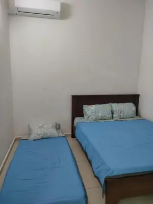 two beds sitting next to each other in a room at Pangkor Shu Yuan \u90a6\u54af\u5c9b\u5885\u82d1\u6d77\u6ee9\u522b\u5885 in Pangkor