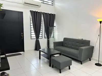 a living room with a couch and a table and a tv at ZN LODGE at KAMUNTING in Kamunting