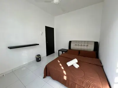 a bedroom with a bed with two paper towels on it at ZN LODGE at KAMUNTING in Kamunting