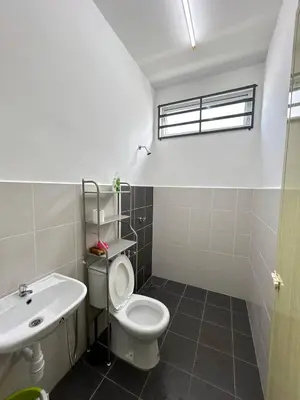 a bathroom with a white toilet and a sink at ZN LODGE at KAMUNTING in Kamunting