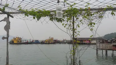 a group of boats in a body of water at Pangkor Fish House in Pangkor