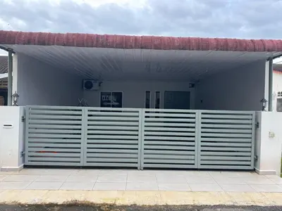a garage with a white fence and a building at Wika Homestay in Kulim