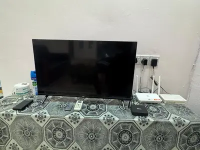 a flat screen tv sitting on top of a table at Wika Homestay in Kulim