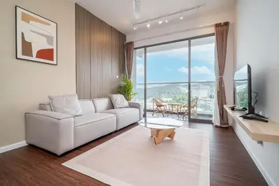 a living room with a white couch and a large window at Serene Japandi Family Retreat 2-7pax &Sunrise View in Brinchang