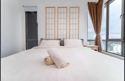 a bedroom with a large white bed with windows at Serene Japandi Family Retreat 2-7pax &Sunrise View in Brinchang