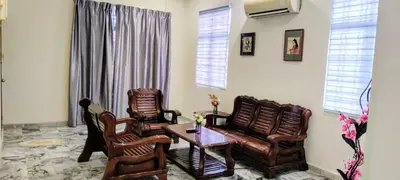 a living room with two chairs and a table at 13paxs Semi D Homestay Hutan Melintang in Hutan Melintang