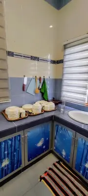 a bathroom with several fish tanks and a sink at 13paxs Semi D Homestay Hutan Melintang in Hutan Melintang