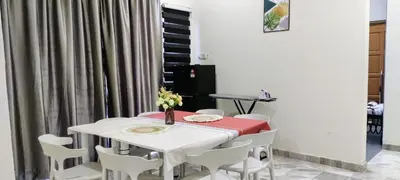 a dining room with a white table and white chairs at 13paxs Semi D Homestay Hutan Melintang in Hutan Melintang
