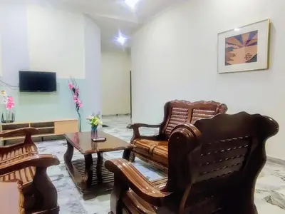 a living room with two chairs and a table at 13paxs Semi D Homestay Hutan Melintang in Hutan Melintang