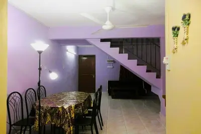 a dining room with a table and a purple wall at NO DEPOSIT - BIG Home 2-sty Terrace Near World Theme Park Hot Springs & Night Park max 6person in Ipoh