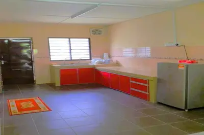 a kitchen with red cabinets and a stainless steel refrigerator at NO DEPOSIT - BIG Home 2-sty Terrace Near World Theme Park Hot Springs & Night Park max 6person in Ipoh