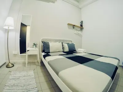 a white and blue bedroom with a large bed at 35Mandalay at Georgetown 5 bedroom for 7-15 pax in George Town