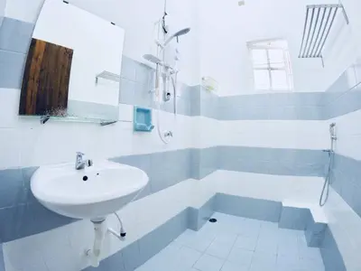 a white bathroom with a sink and a tub at 35Mandalay at Georgetown 5 bedroom for 7-15 pax in George Town