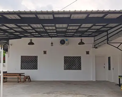 a large white room with a ping pong table at HT Home in Ipoh
