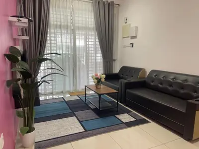 a living room with a couch and a table at Homestay Sakura in Padang Serai