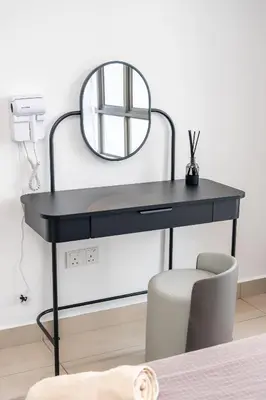 a black desk with a mirror and a chair at Serene Minimalist Family Retreat 2-7pax &Sunrise View in Brinchang
