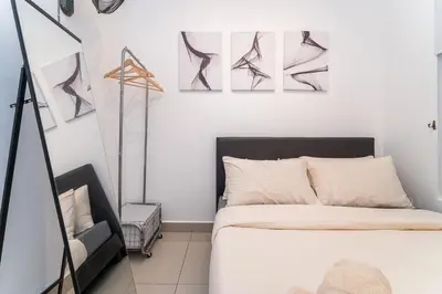 a bedroom with a bed and paintings on the wall at Serene Minimalist Family Retreat 2-7pax &Sunrise View in Brinchang