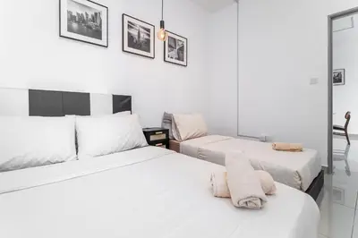 a bedroom with two beds with towels on the bed at Serene Minimalist Family Retreat 2-7pax &Sunrise View in Brinchang